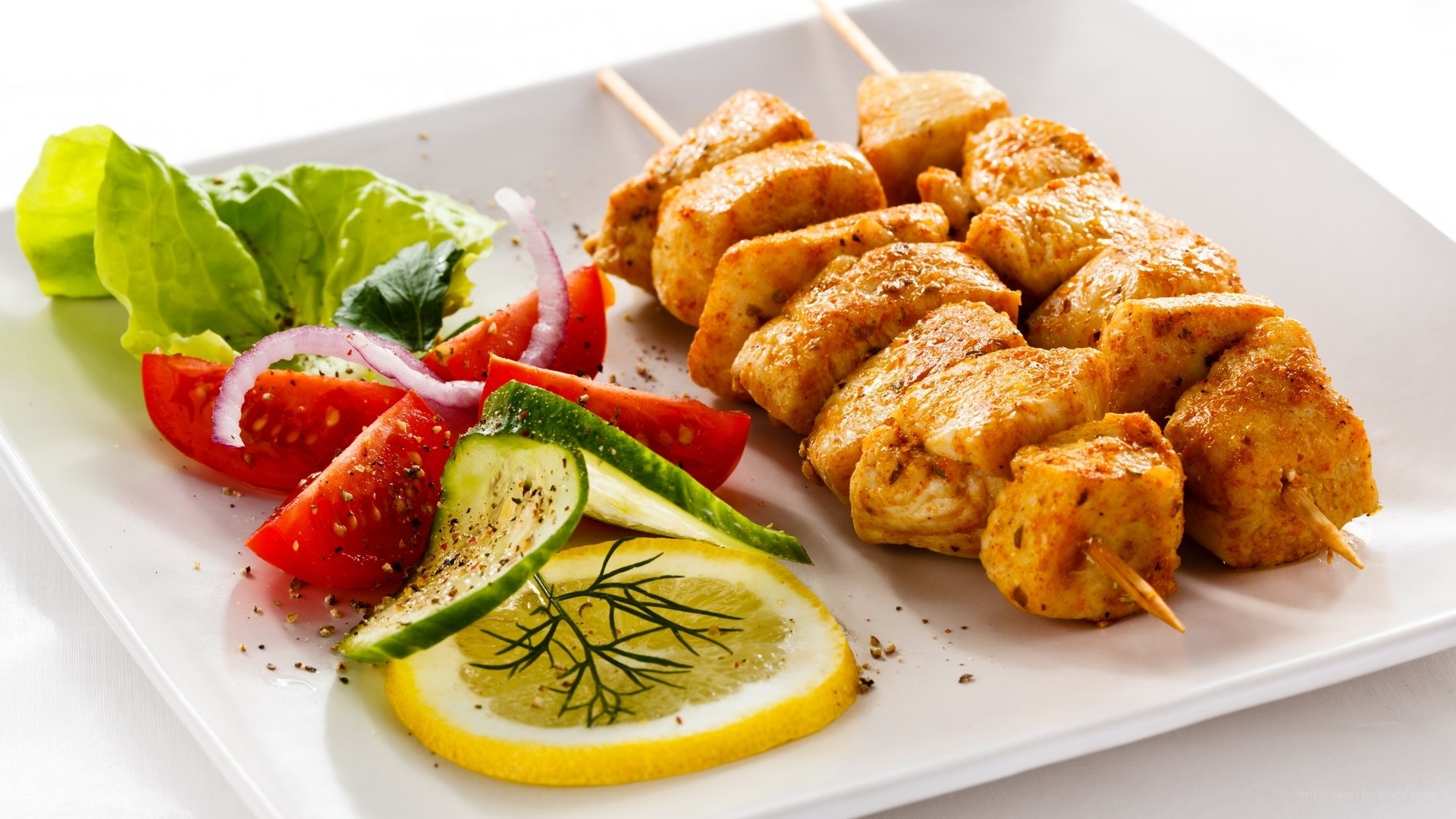 Grilled chicken skewers with salad