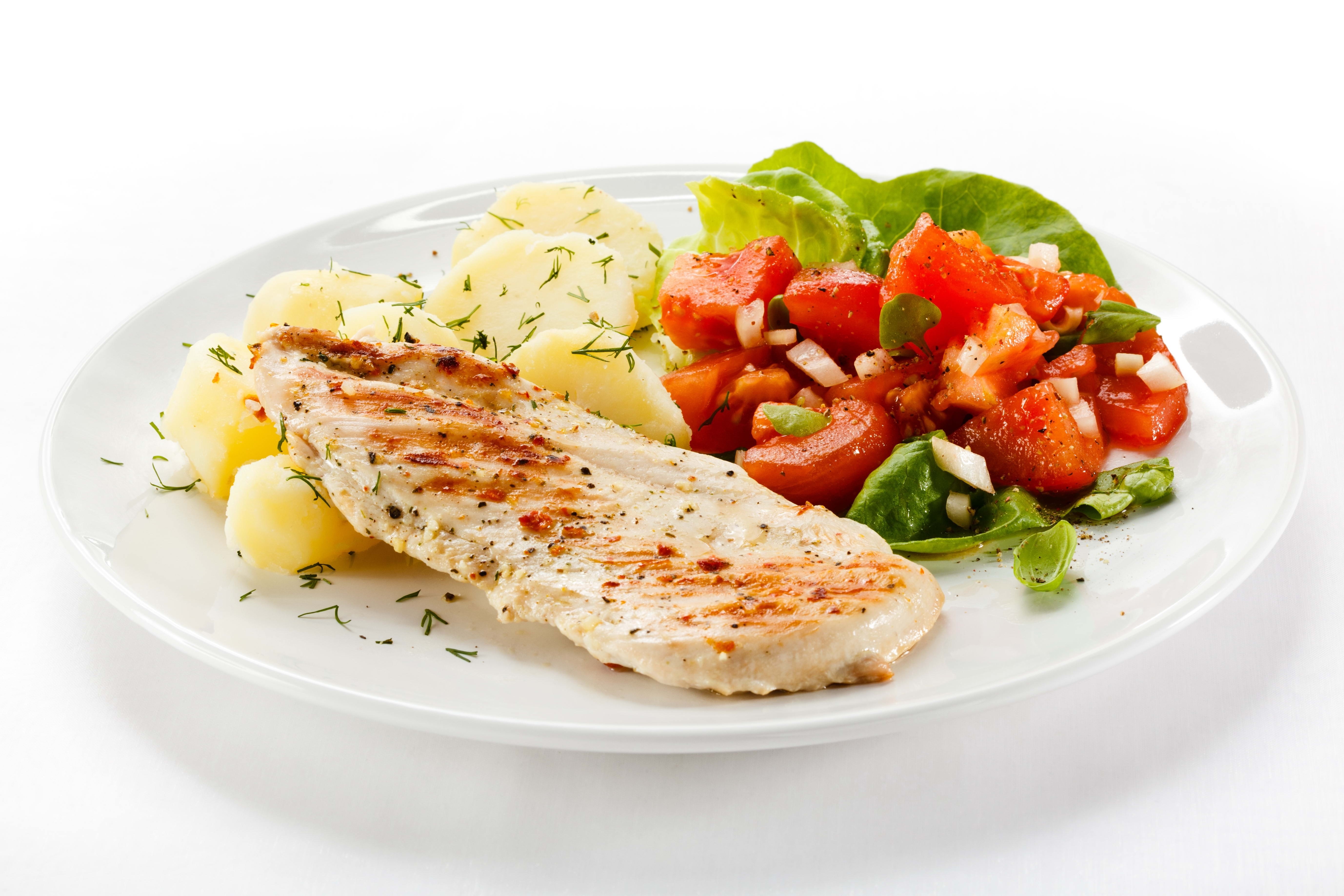 grilled chicken with salad and potatoes