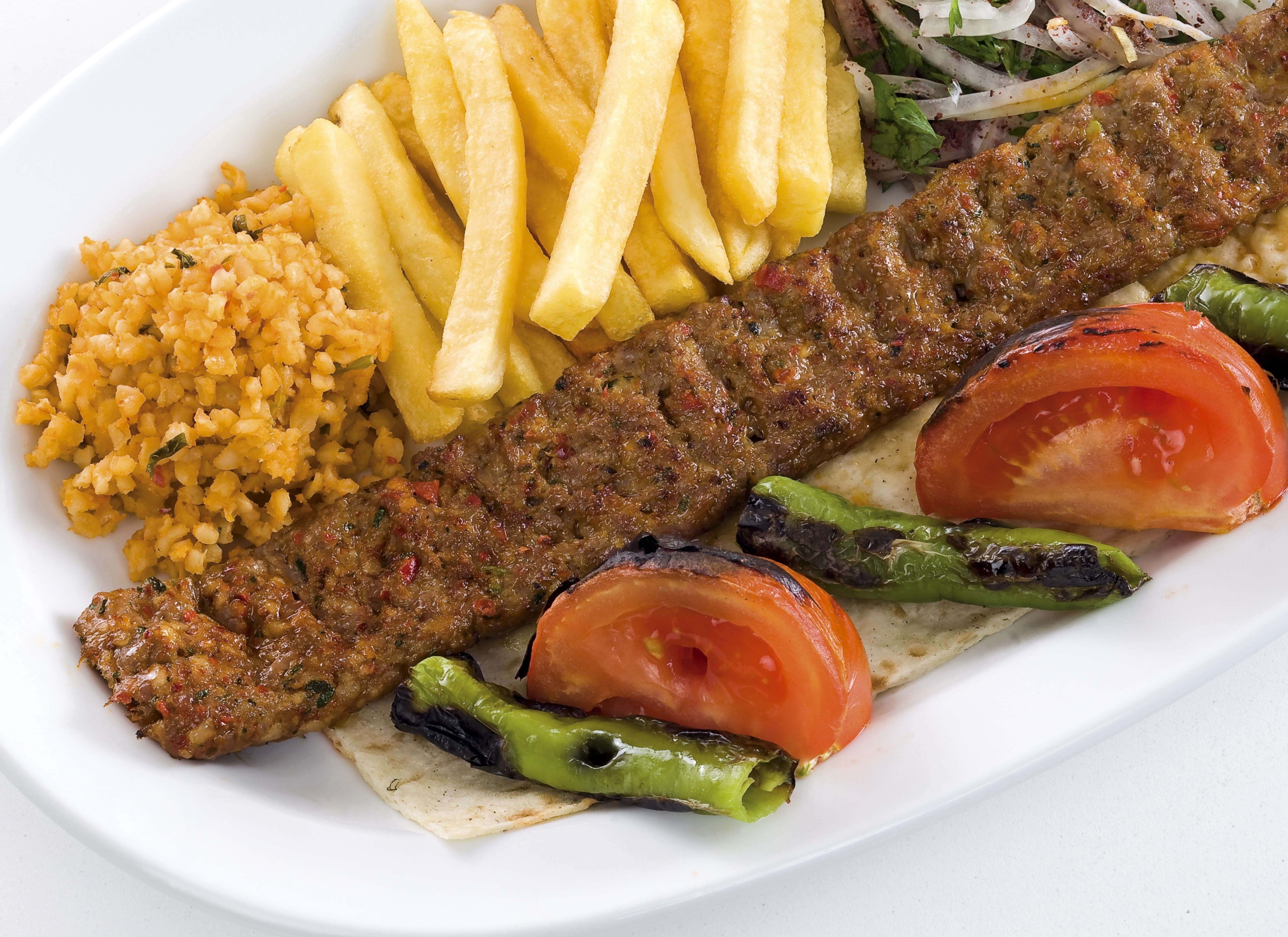 Grilled meat skewer with fries
