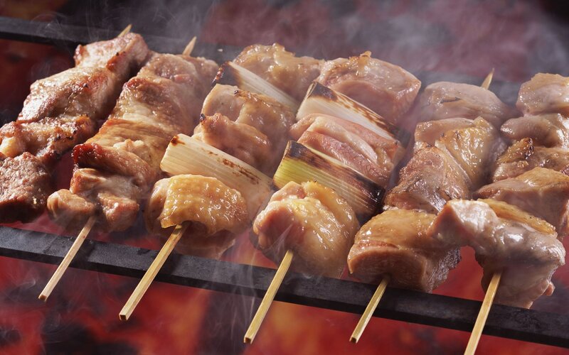Grilled meat skewers on a grill