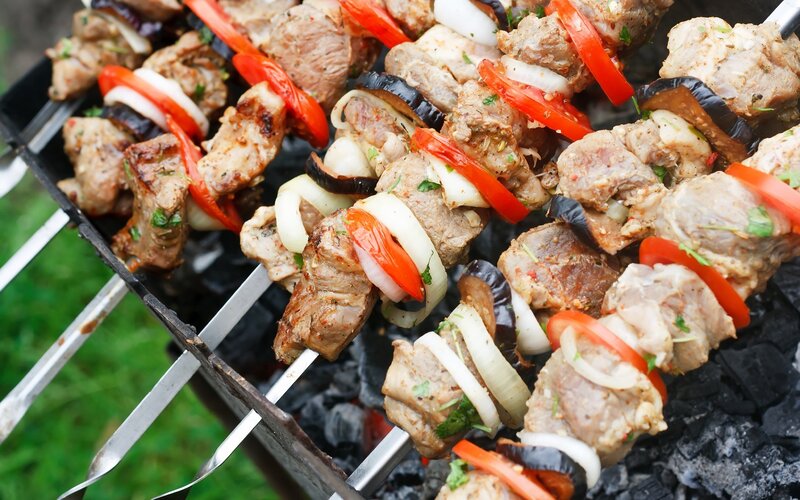 Grilled meat skewers on charcoal