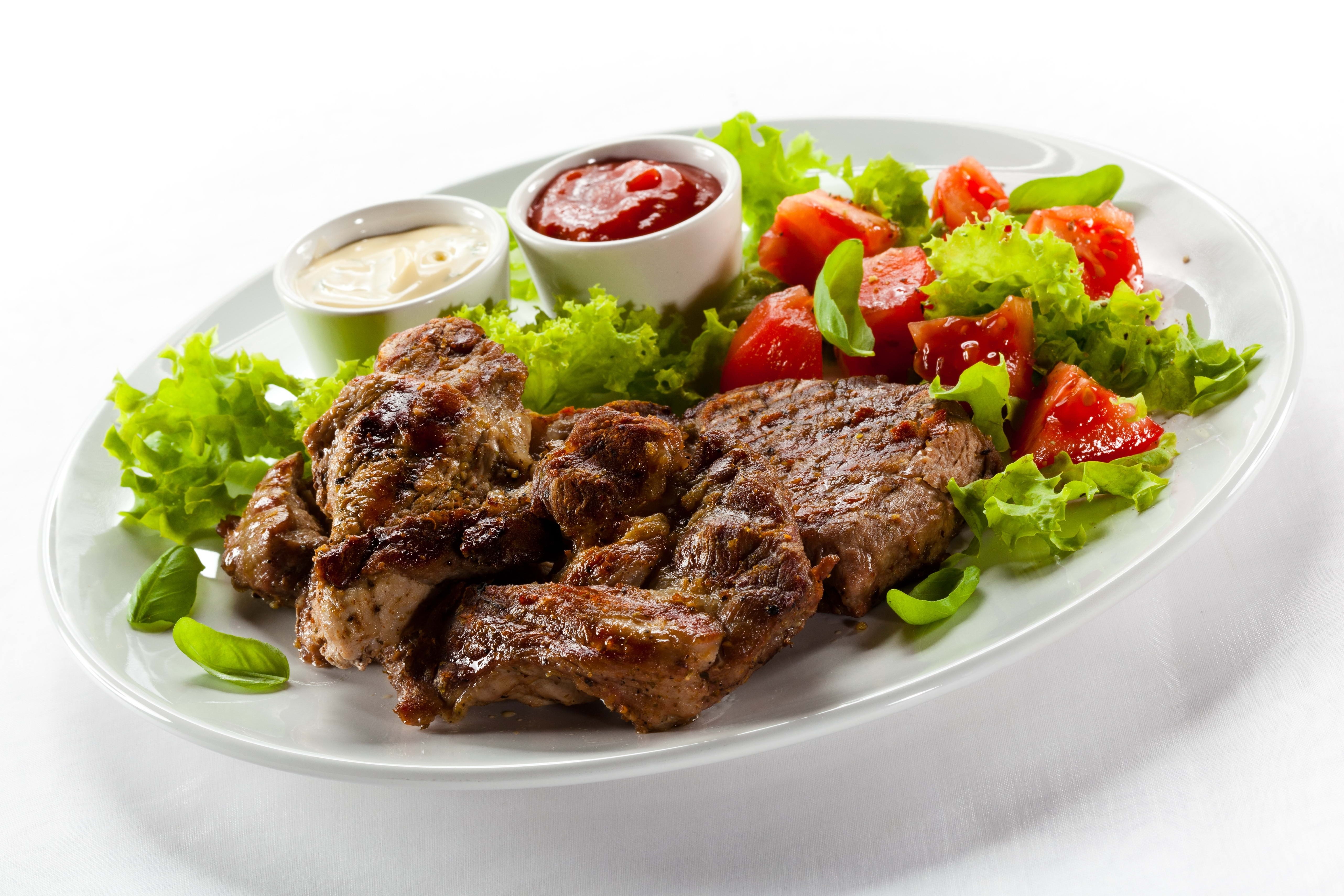 Grilled meat with salad and sauces
