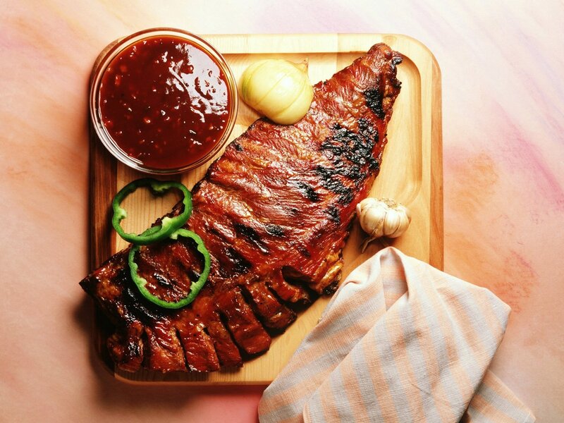 Grilled ribs with sauce and garnish