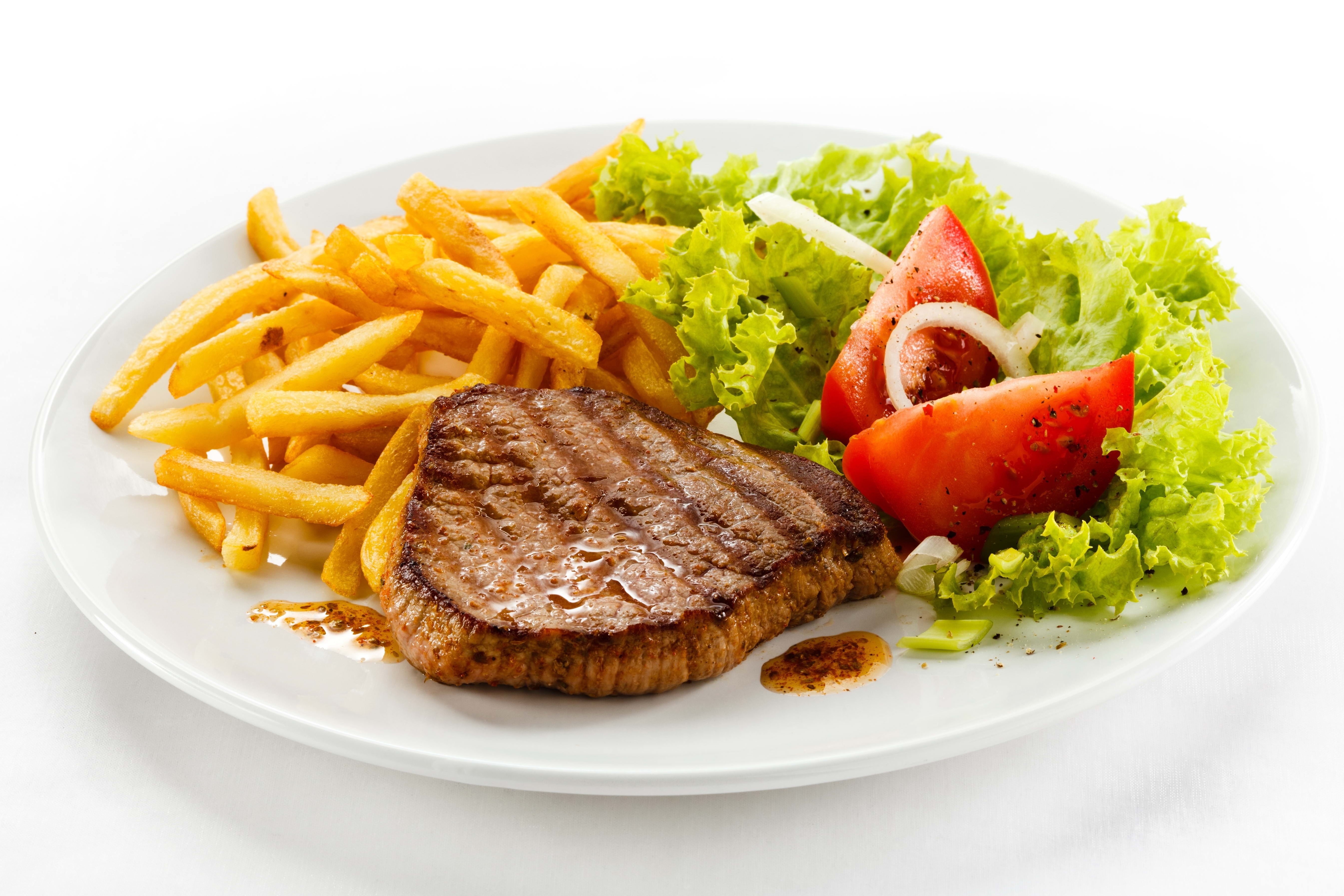Grilled steak with fries and salad