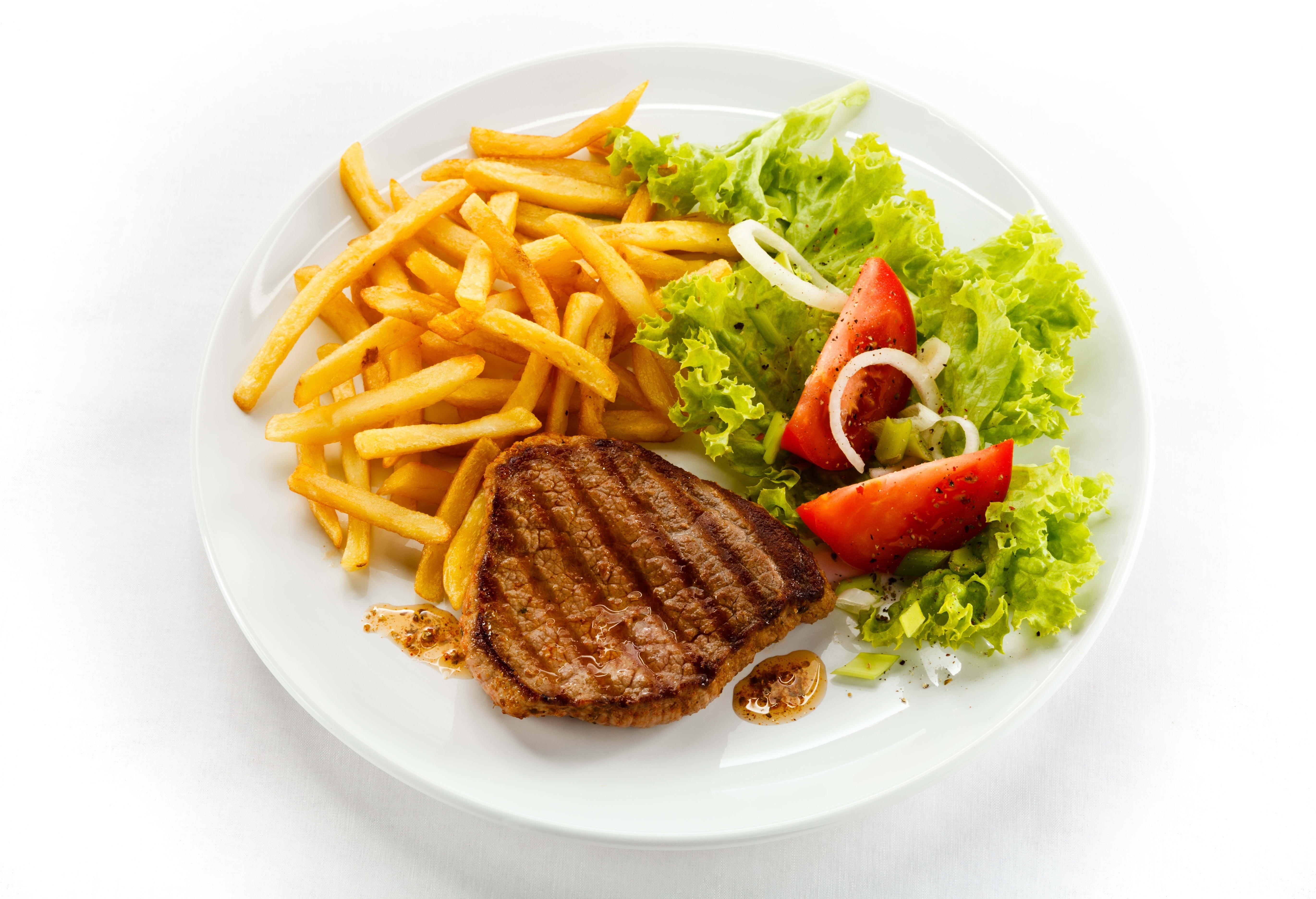 Grilled steak with fries and salad