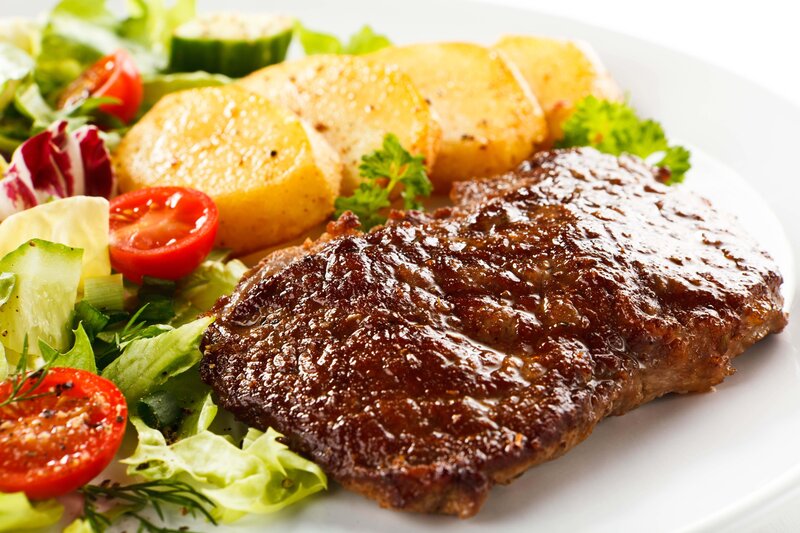 Grilled steak with salad and potatoes