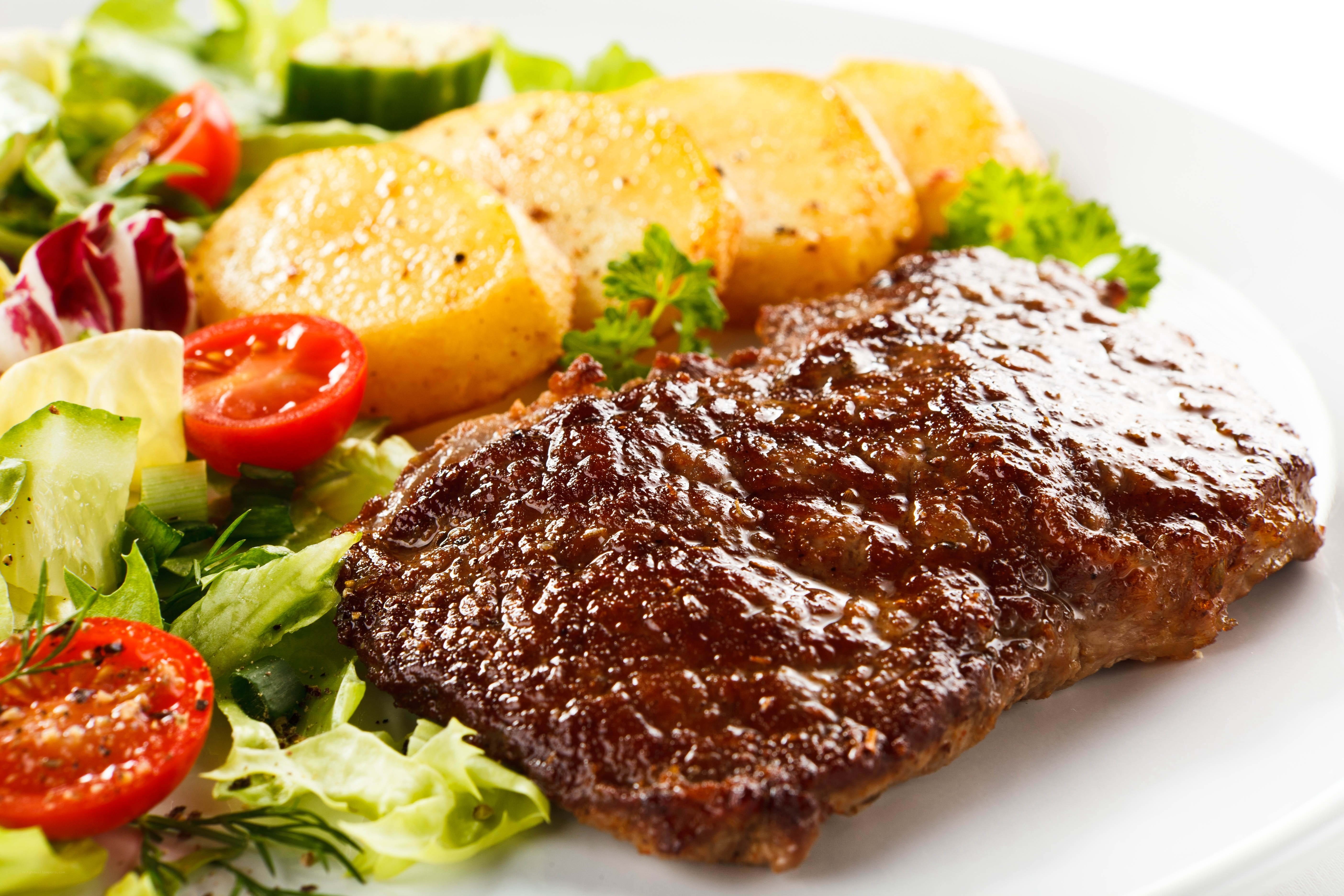 Grilled steak with salad and potatoes