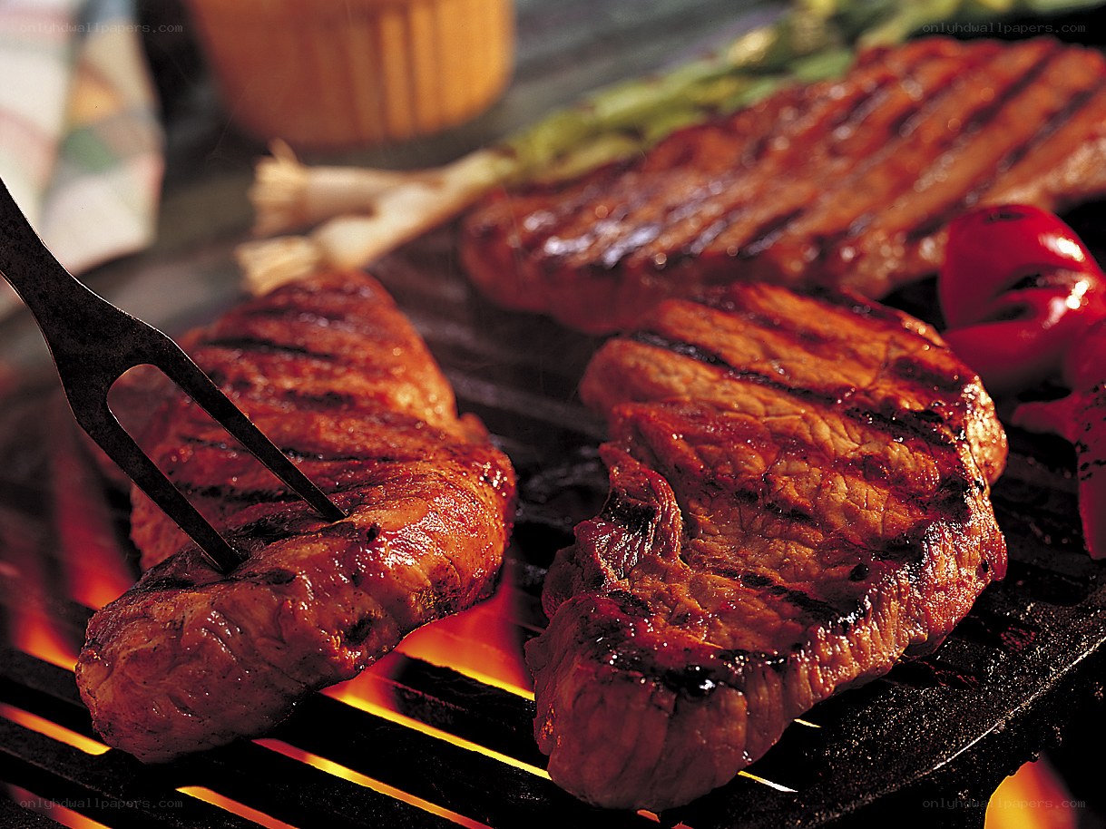 Grilled steaks on a barbecue