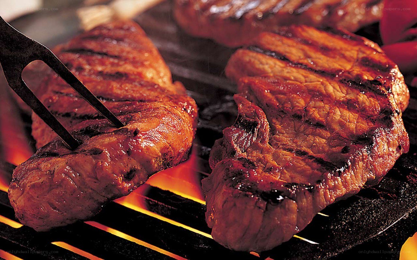Grilled steaks on a barbecue