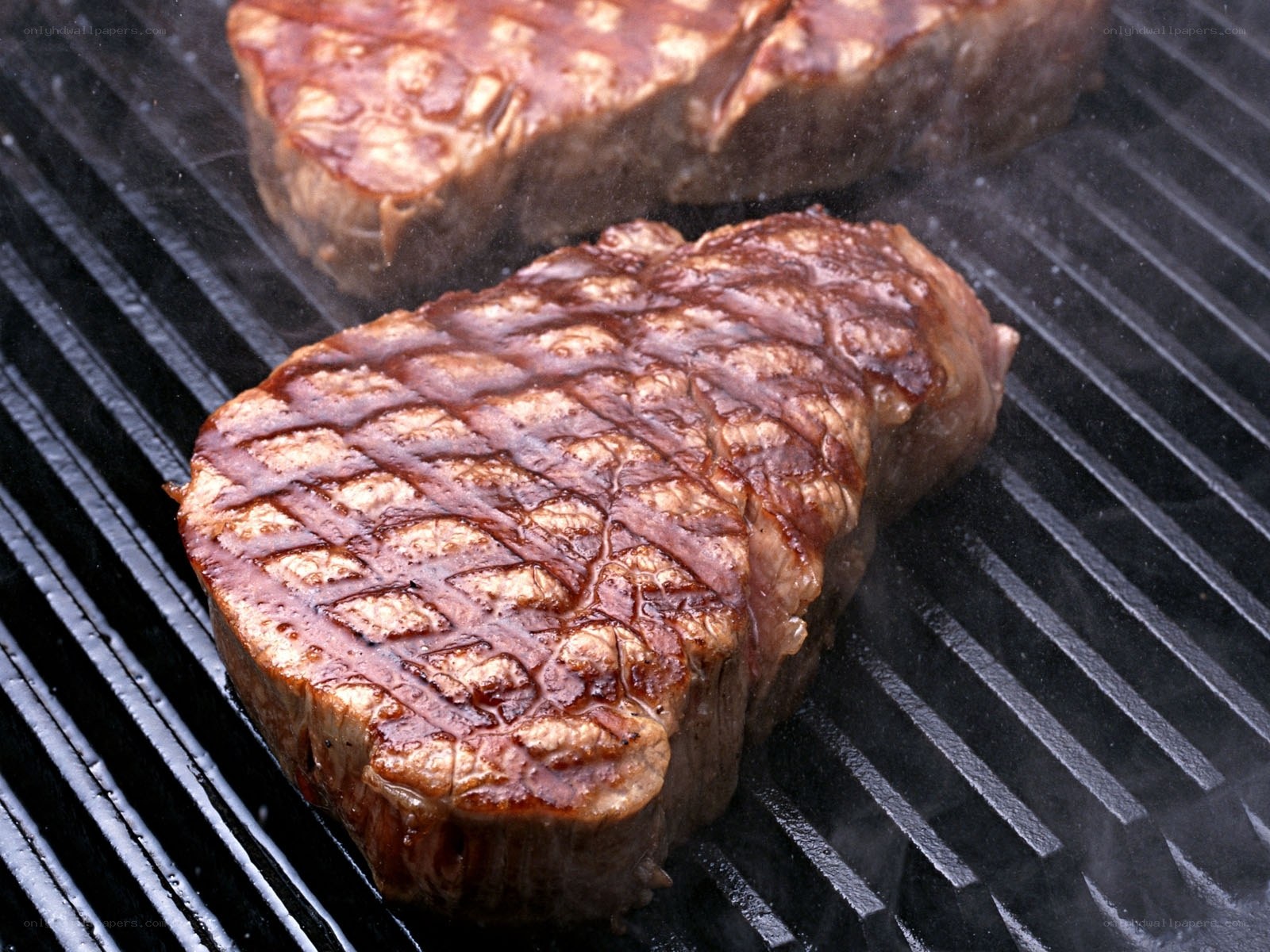 Grilled steaks on a grill