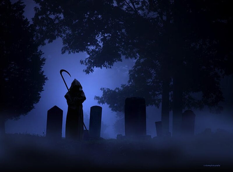 Grim reaper in a foggy graveyard
