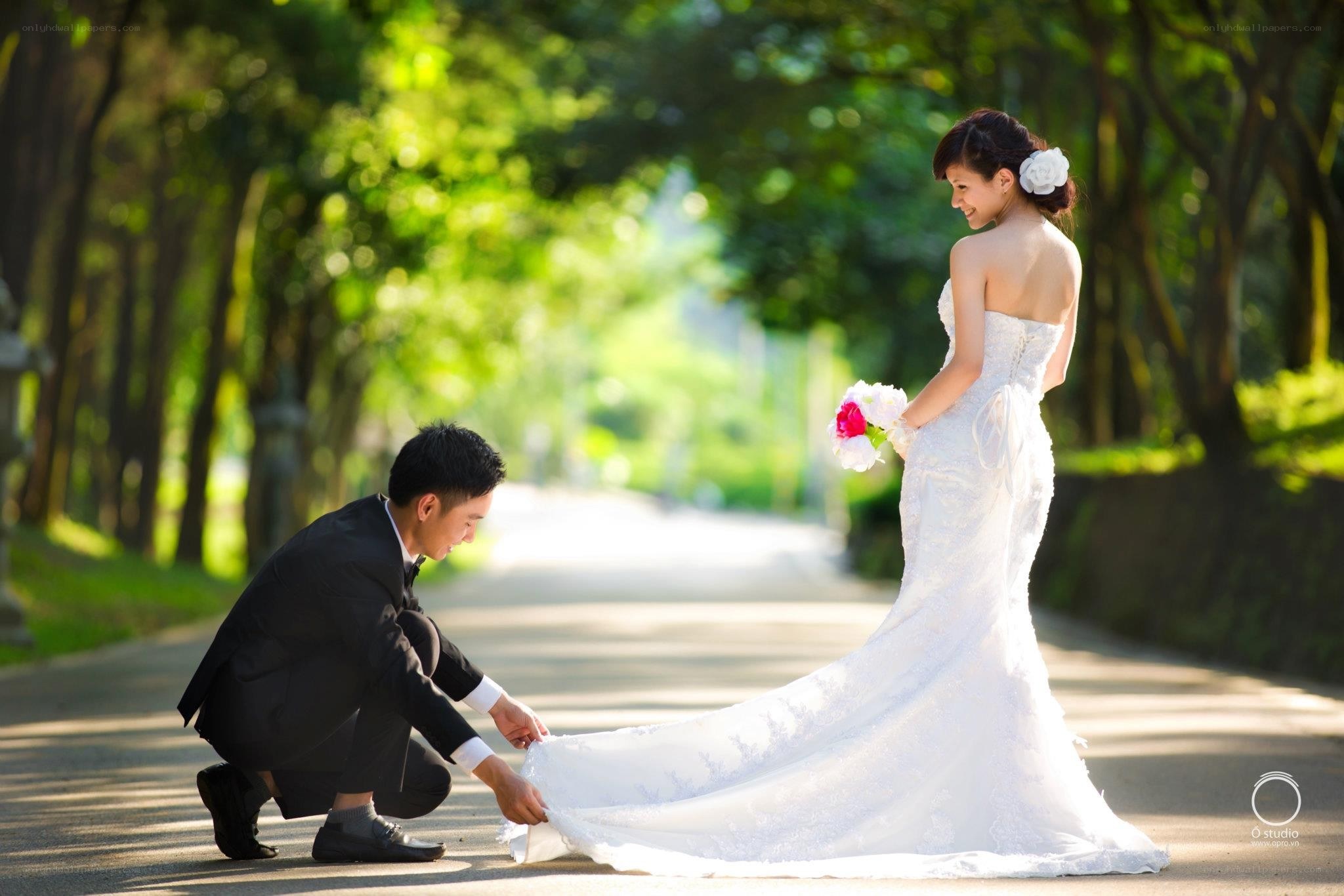 Groom assists bride on path