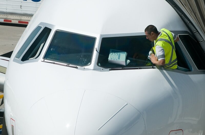 Ground crew at airplane cockpit