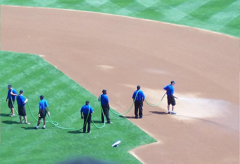 Grounds crew watering baseball field