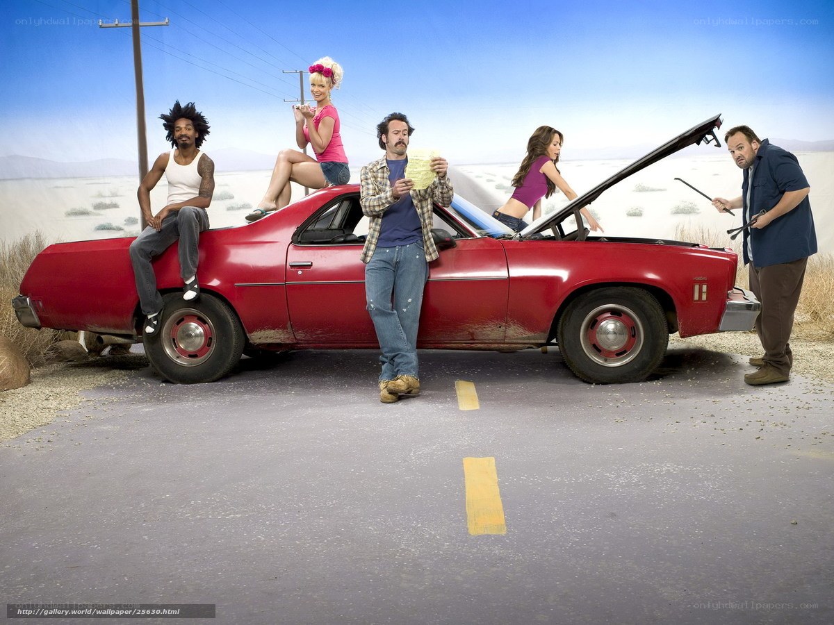 Group around red car in desert