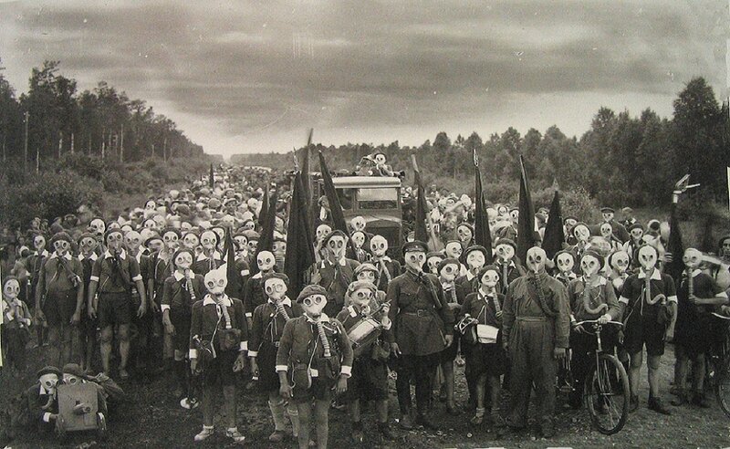 Group in gas masks on road