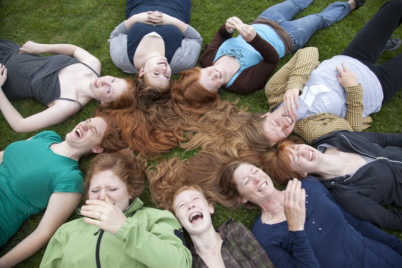 Group of friends laughing on grass