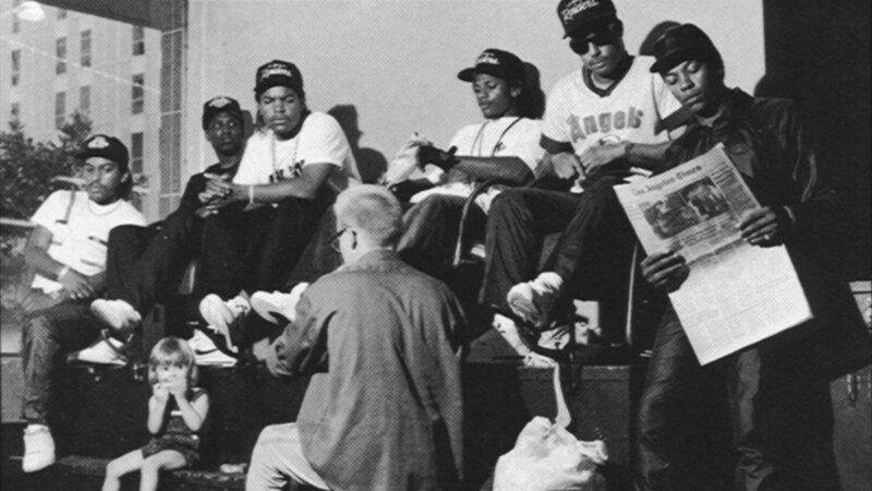 Group of men sitting outdoors