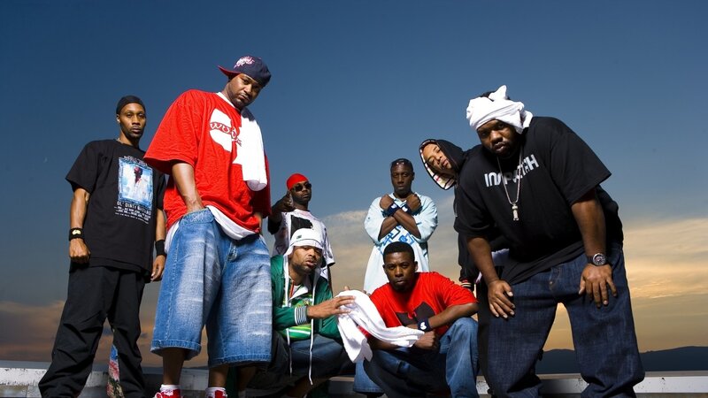 group of rappers posing outdoors