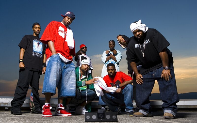 group of rappers posing outdoors