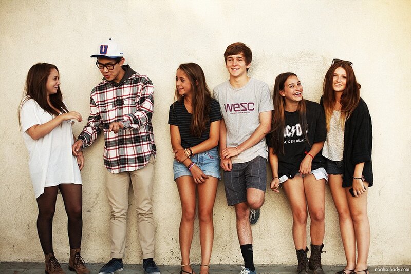 group of teens leaning on wall