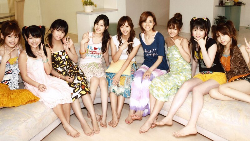 Group of young women posing on a couch