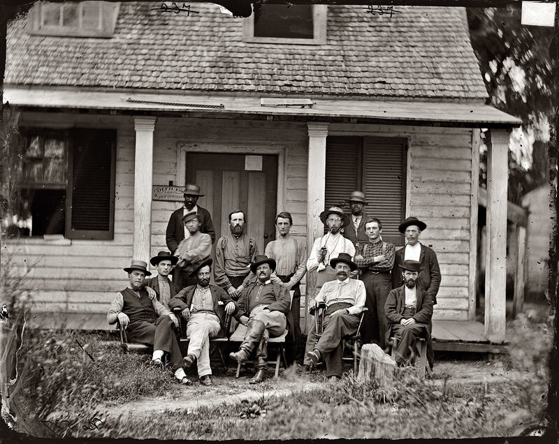 Group portrait outside wooden building