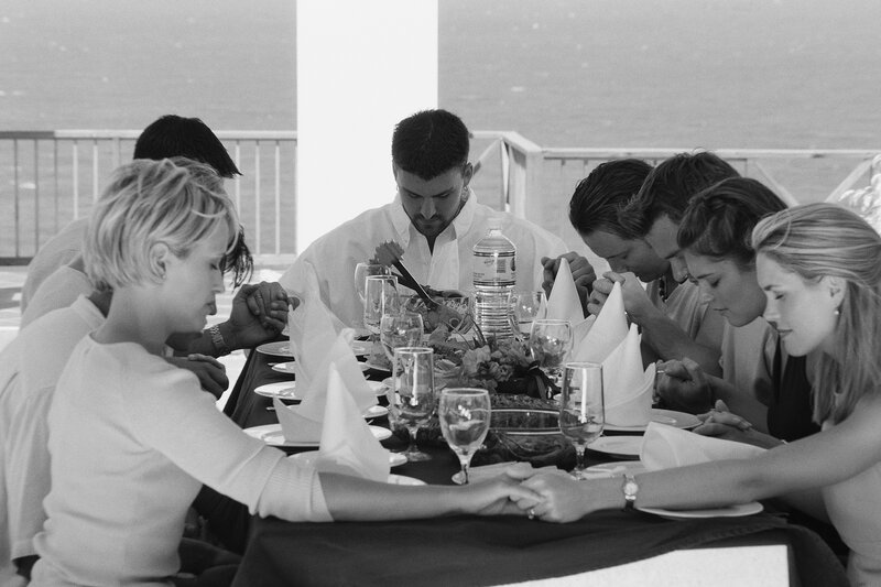 Group prayer at dinner table