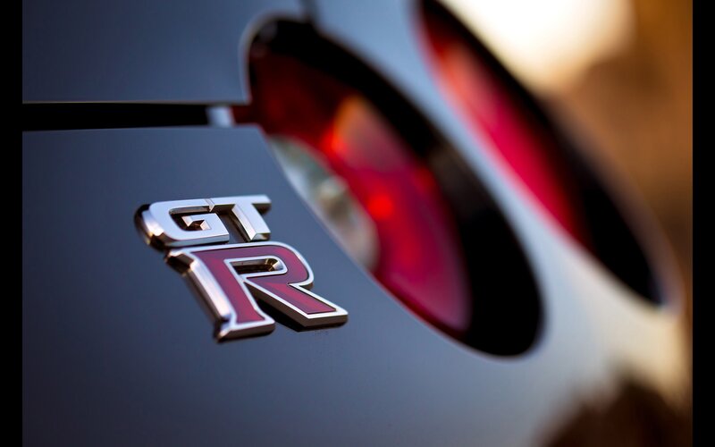 GT-R Emblem on Car — Black, Dramatic, Sunset