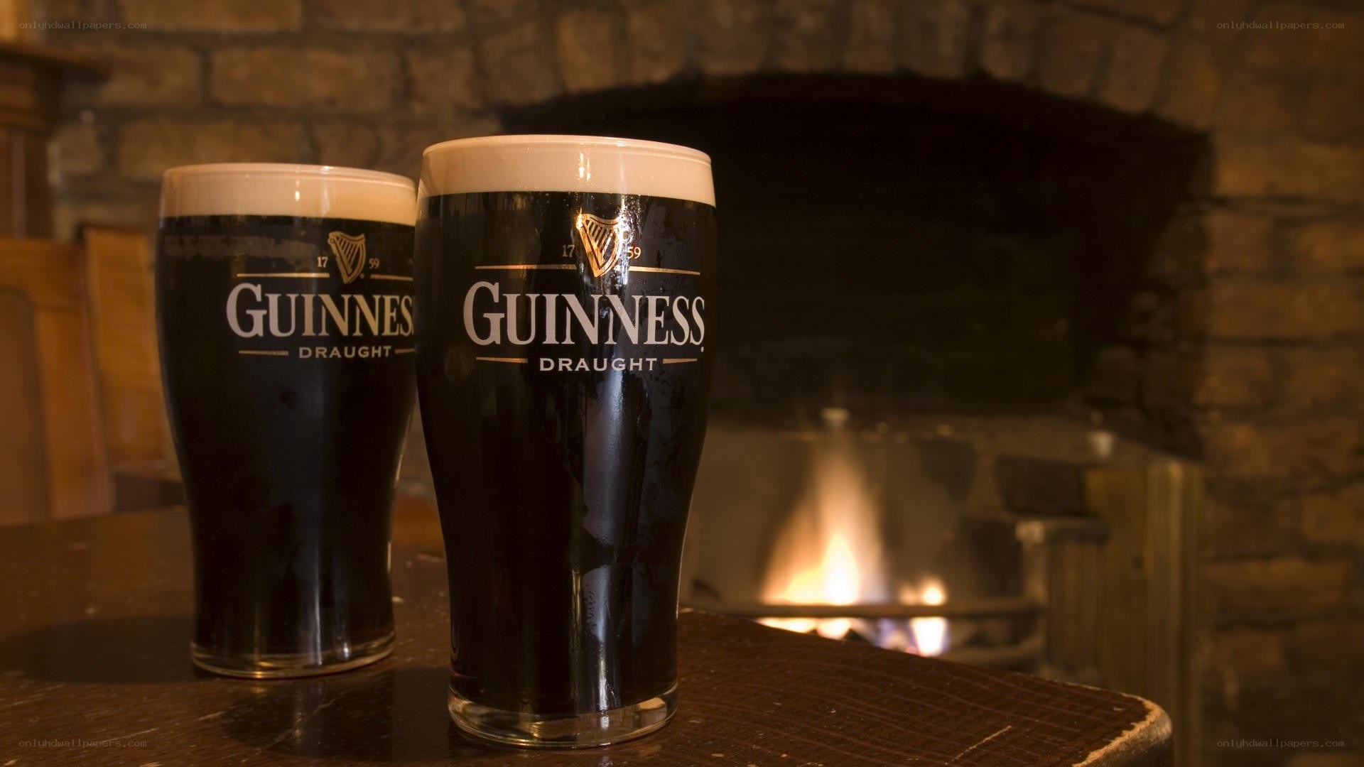 Guinness beers by a fireplace
