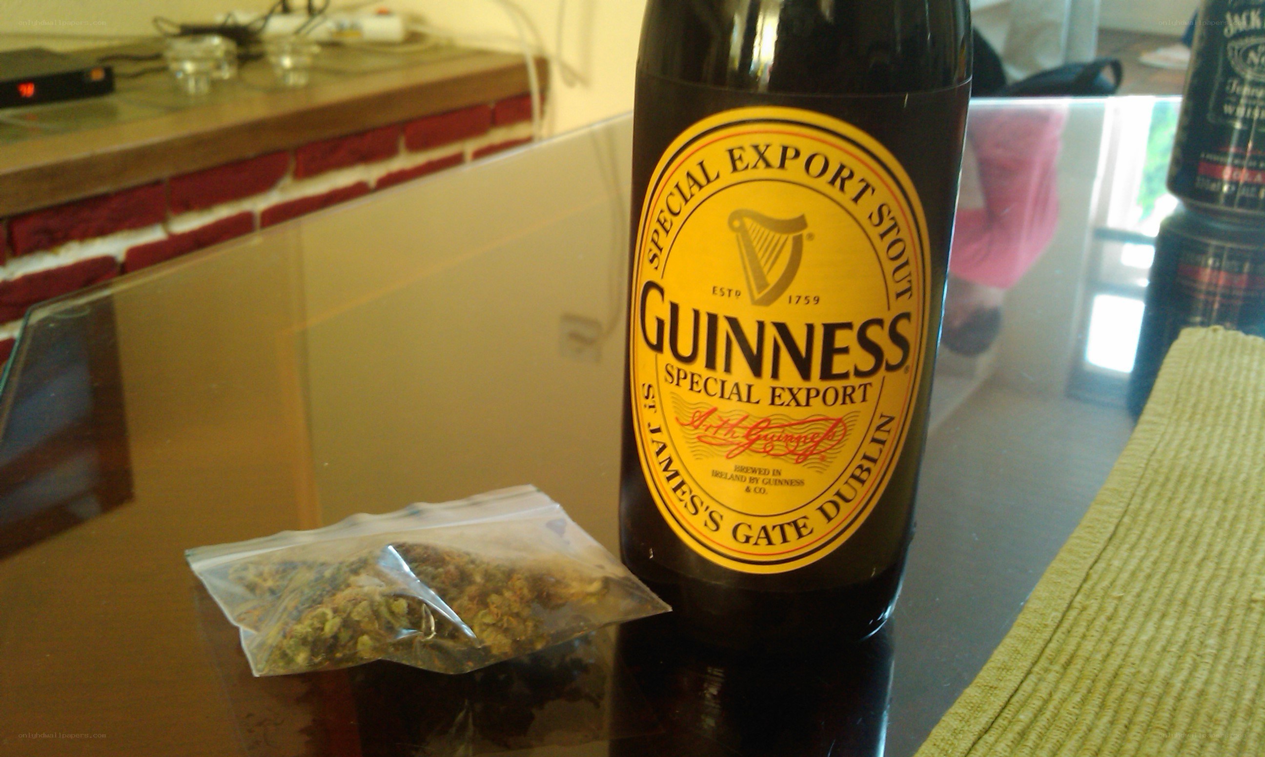 Guinness bottle and herbs on table