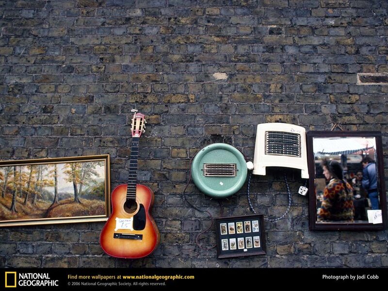 Guitar and items on brick wall