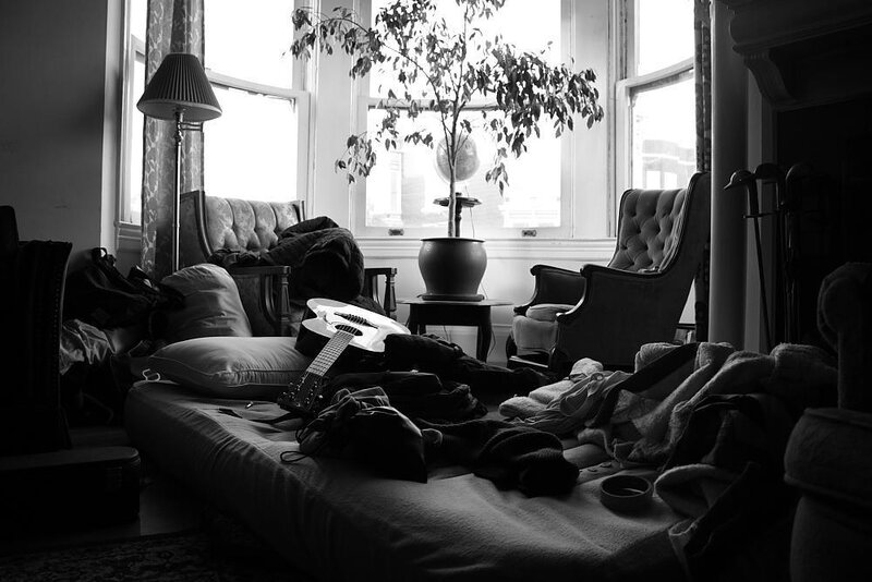 Guitar on Cluttered Bed