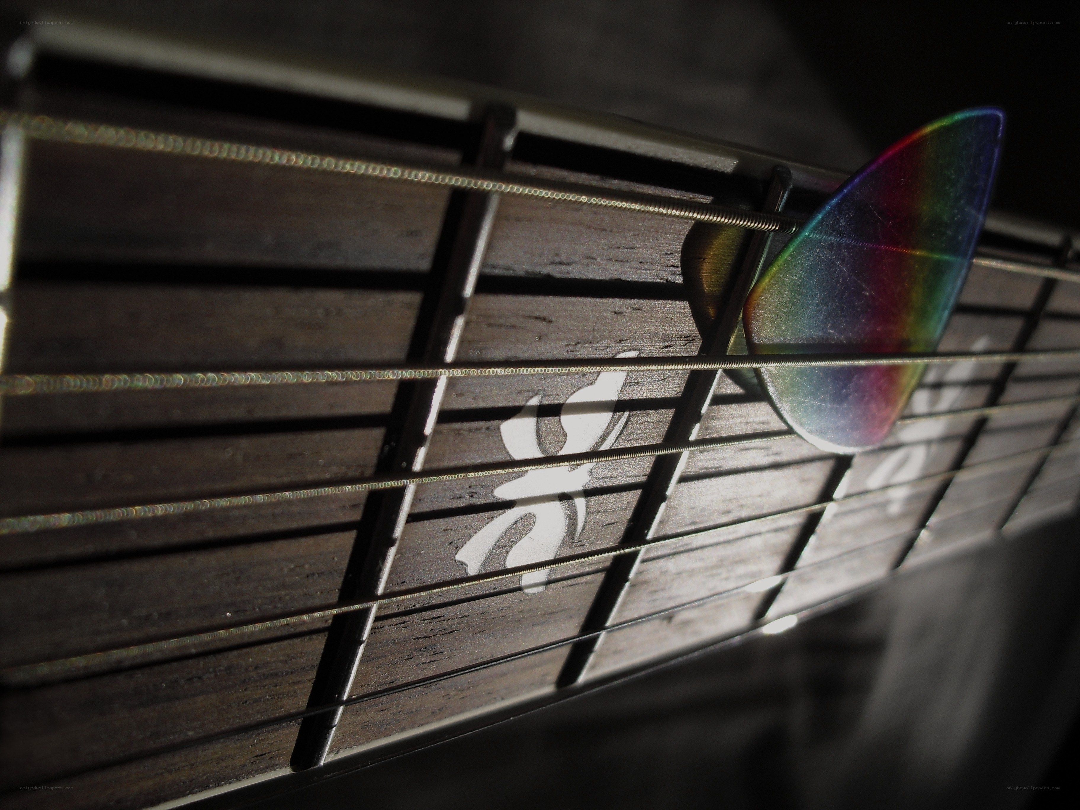 guitar pick on fretboard