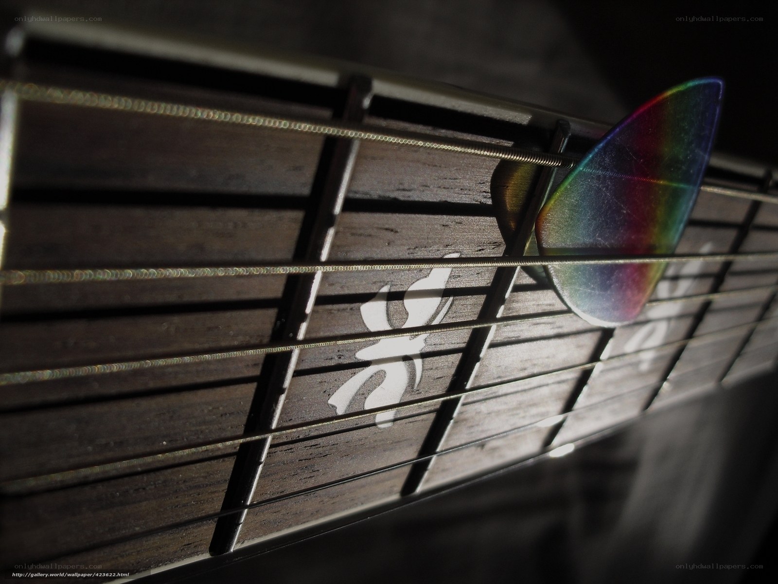 guitar pick on fretboard