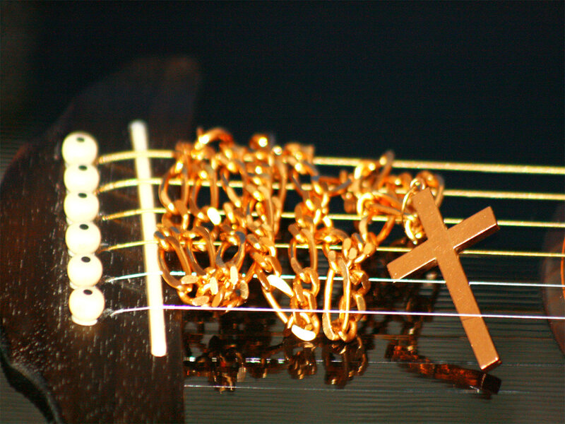 Guitar with cross necklace