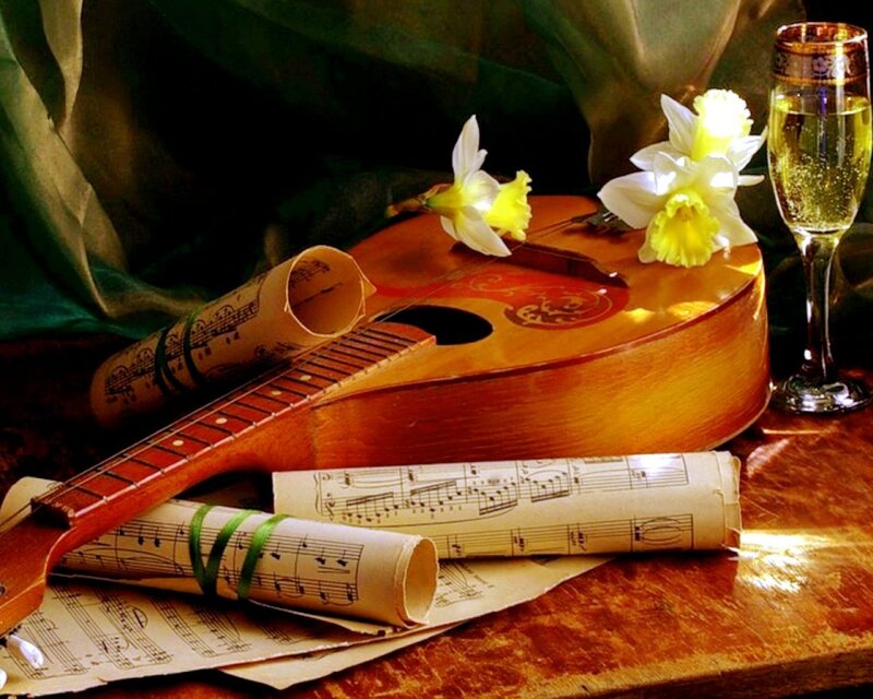 Guitar with sheet music and flowers