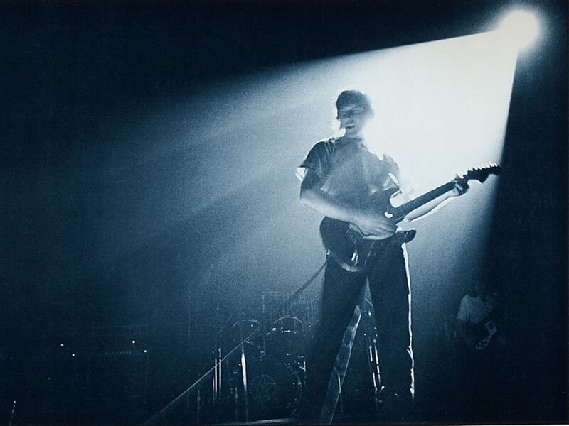 guitarist on stage under spotlight
