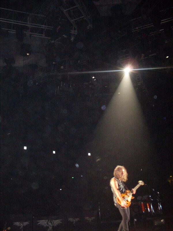 guitarist on stage under spotlight