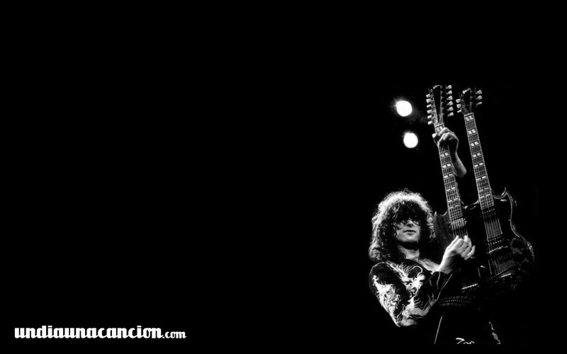 guitarist on stage with dual guitars