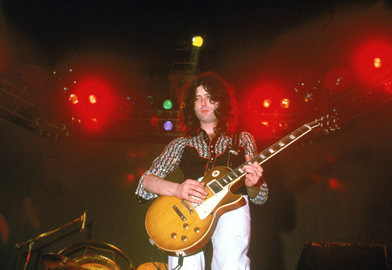 Guitarist on stage with red lights