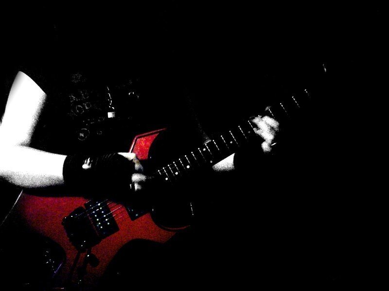 guitarist playing in dark