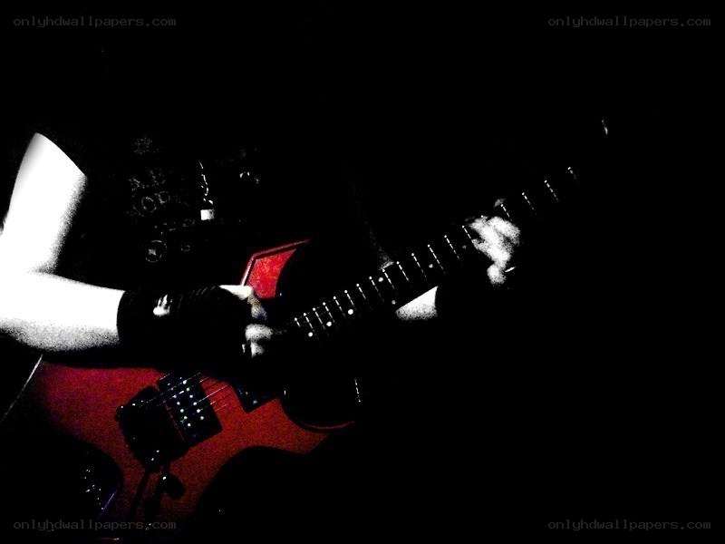 guitarist playing in dark