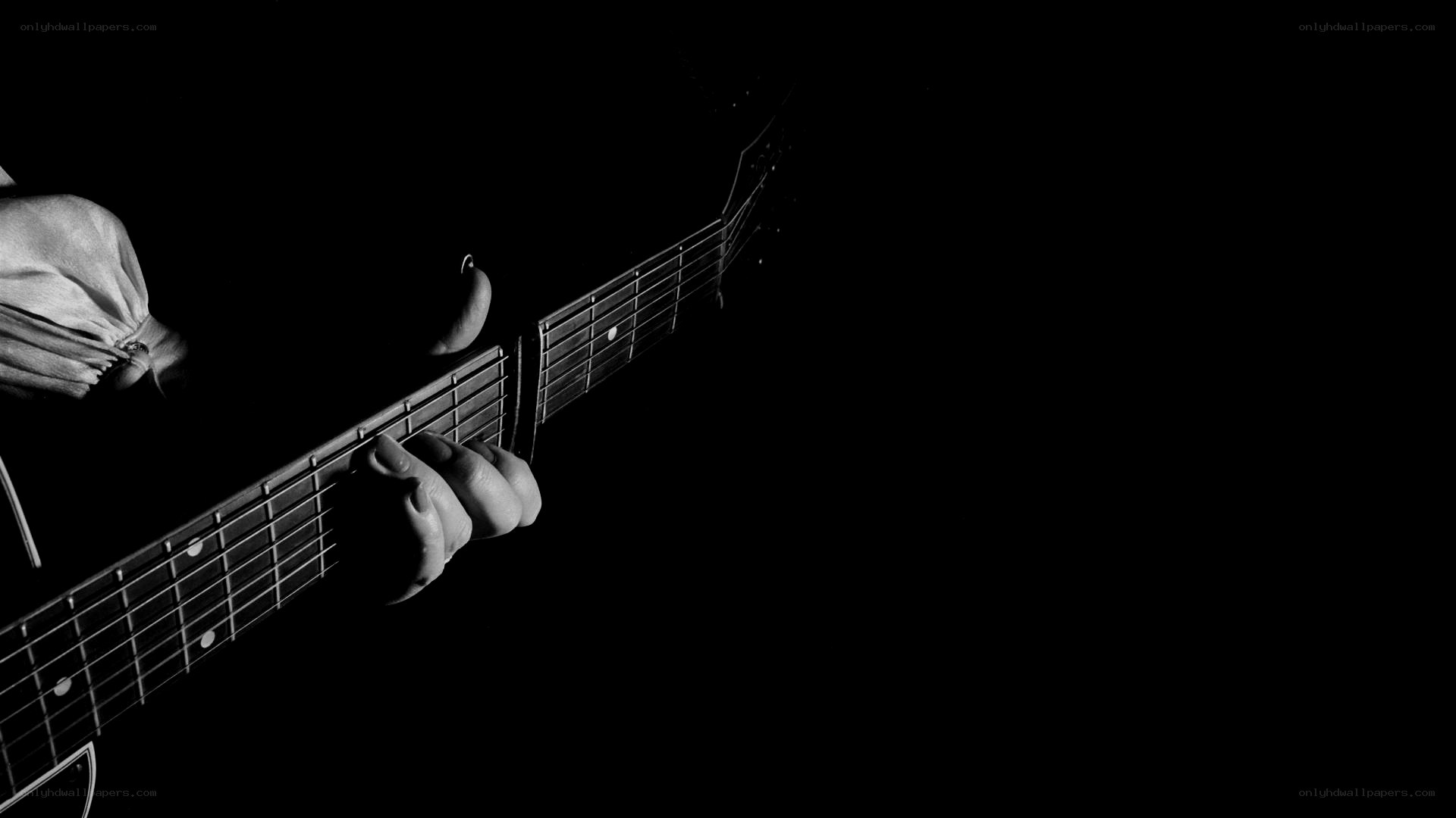 guitarist playing in darkness