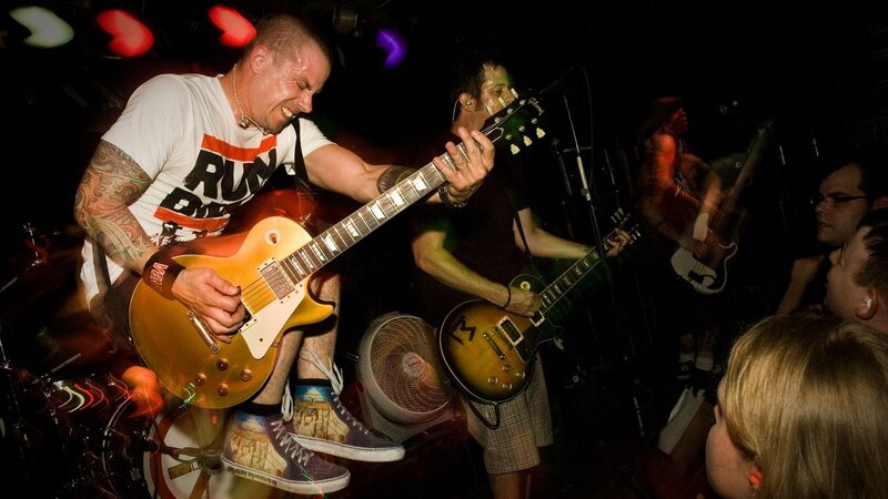 Guitarist Playing on Stage — Black