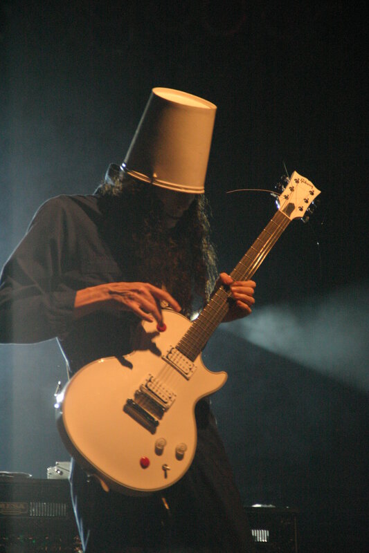 guitarist with bucket on head