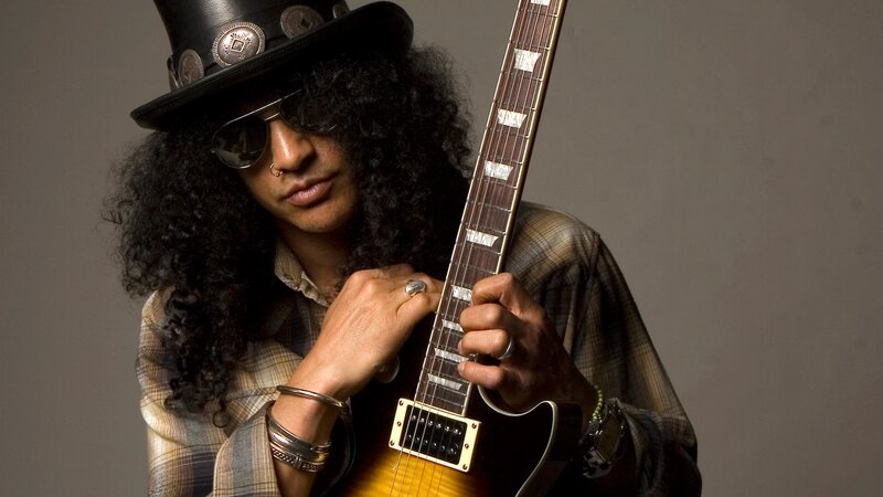Guitarist with curly hair and hat