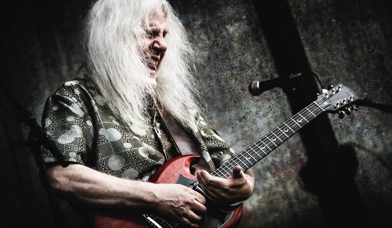guitarist with long white hair