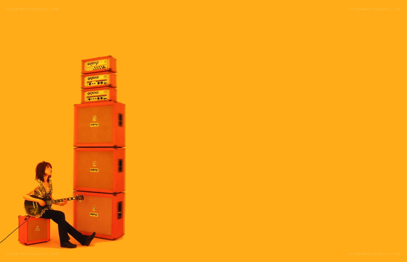 guitarist with orange amplifiers