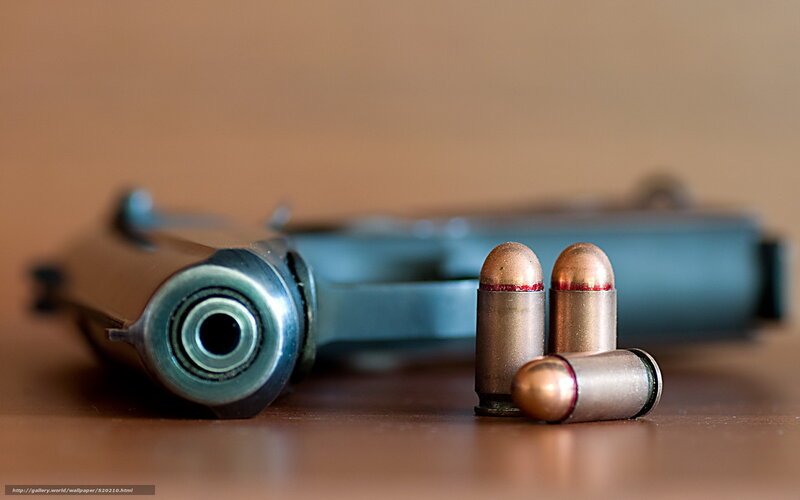 gun and bullets on table